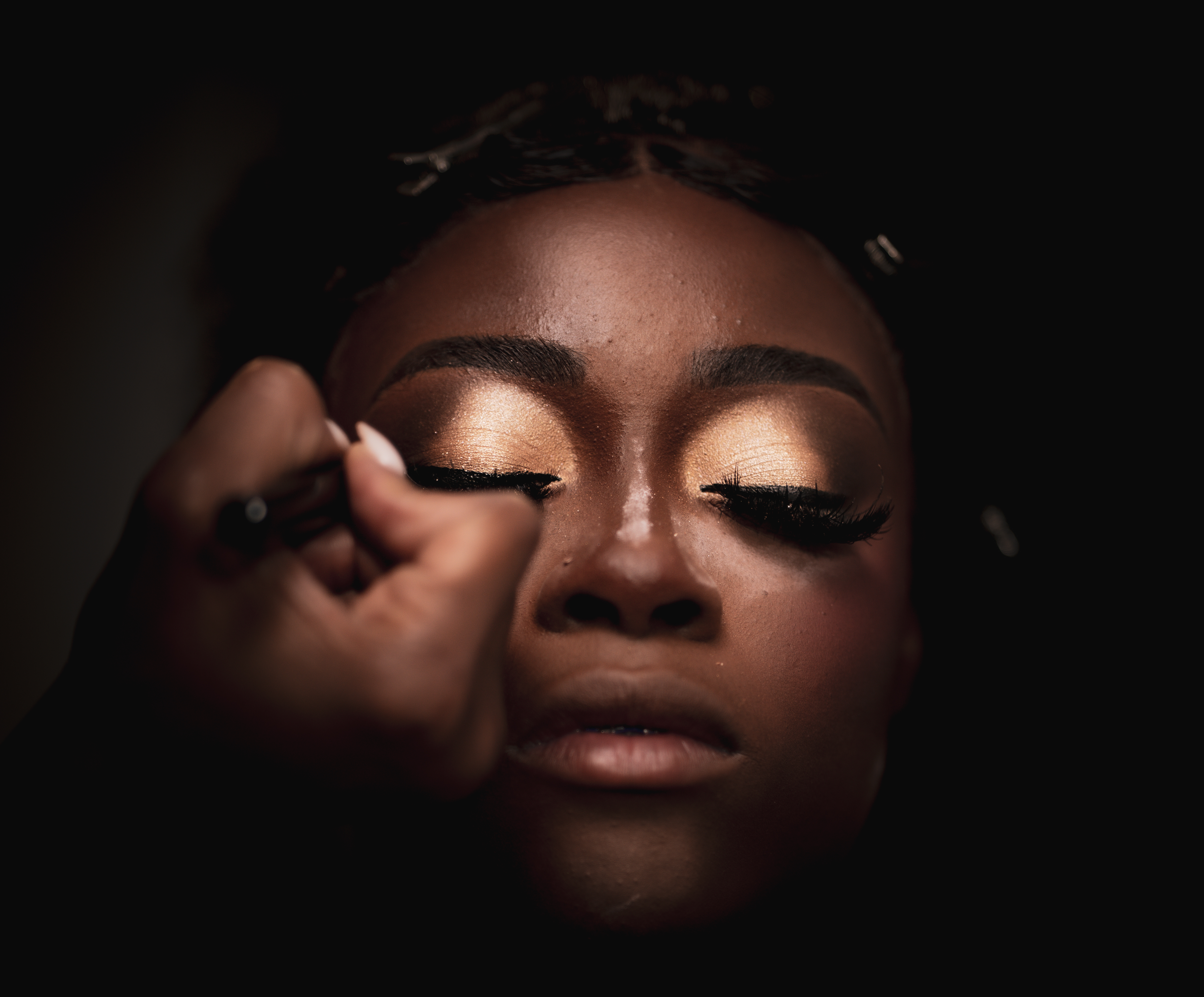 Close-up behind-the-scenes beauty photograph of eyeliner being applied under dramatic light by Big Rich Visuals