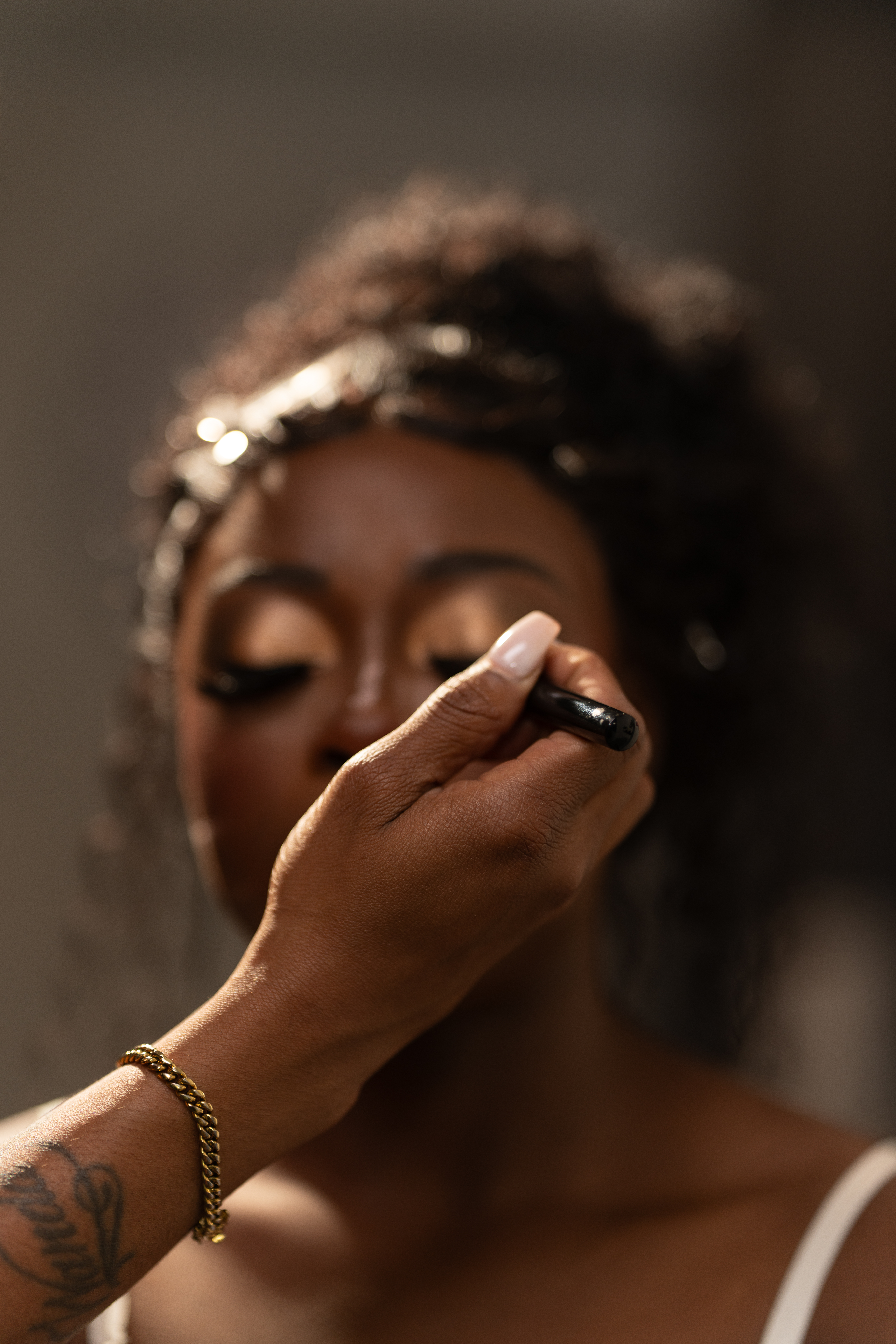 Behind-the-scenes beauty preparation photograph of makeup being applied before a shoot by Big Rich Visuals